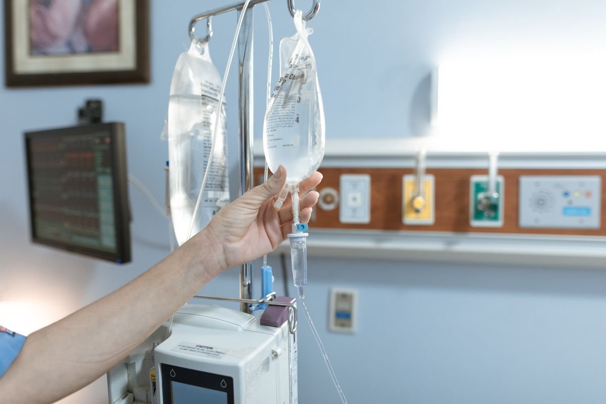 A pharmacist monitoring an IV drip during an infusion at The London Health and IV Clinic