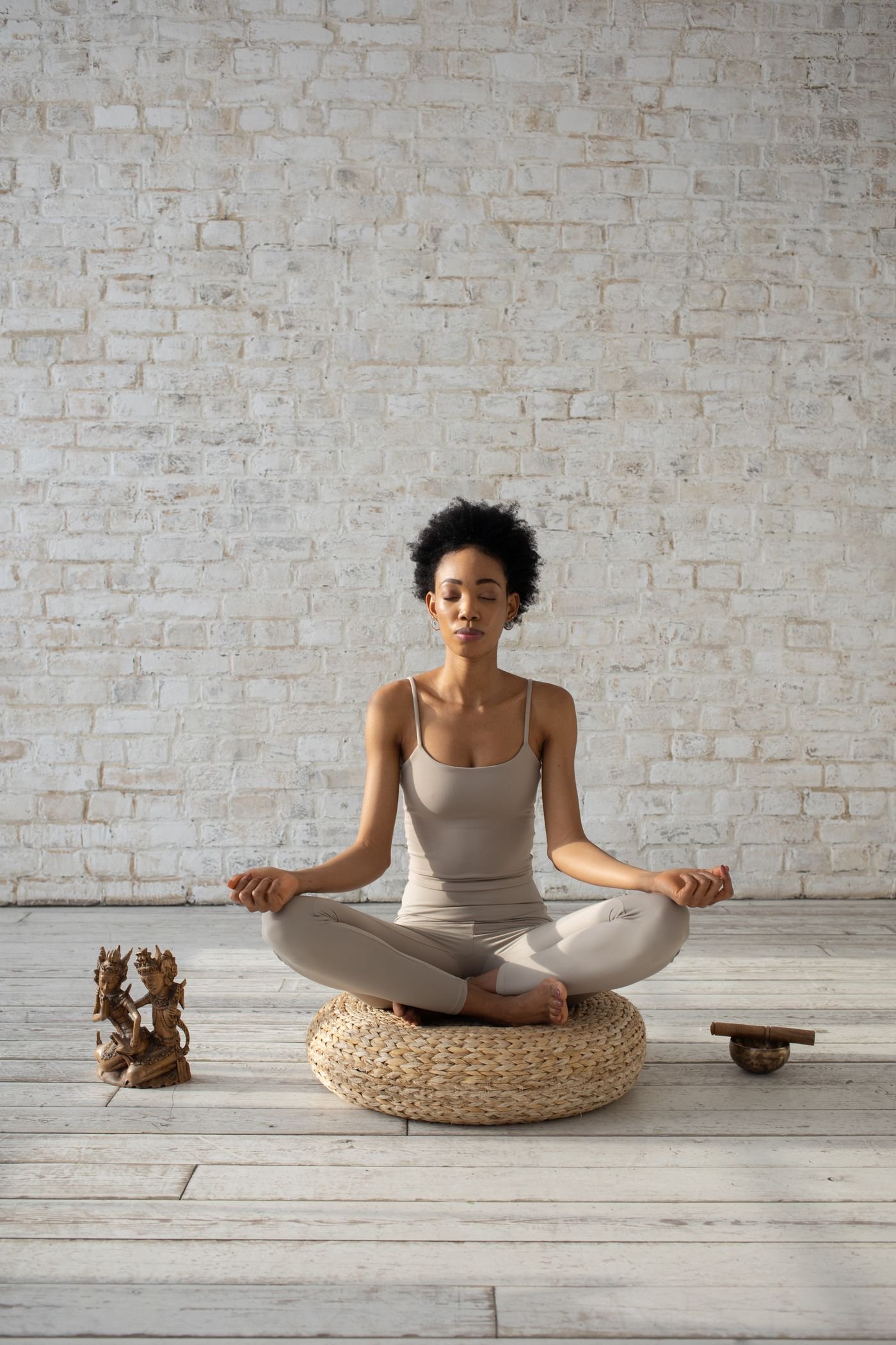 Woman meditating calmly on a cushion